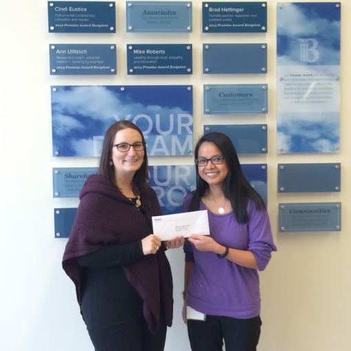 Busey Bank's Mitzi Villalon (right) presents a check to Crime Stoppers' Treasurer Dawn Coyne.